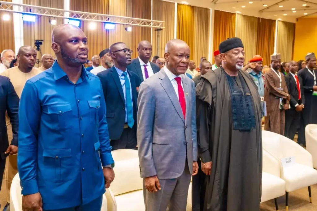 Dr. Olasupo Olusi, Senator John Owan Enoh, and distinguished guests standing at attention during a ceremony at the Cocoa Value Addition Summit