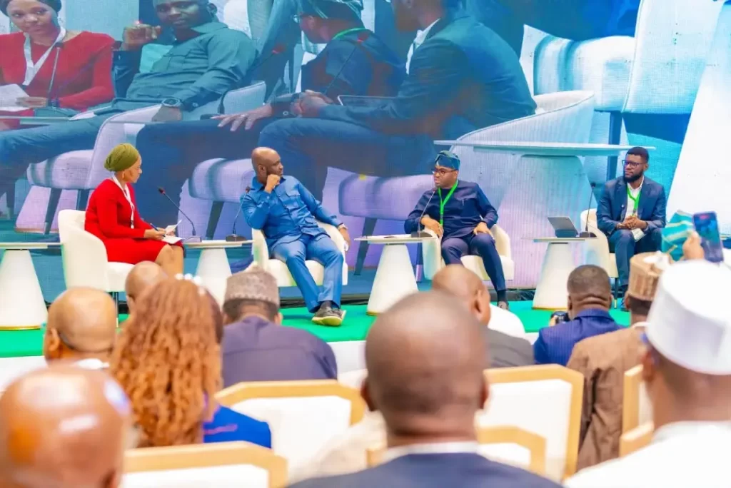 Panelists seated on stage during a panel discussion at the Cocoa Value Addition Summit 2026, featuring Dr. Olasupo Olusi and guest speakers.