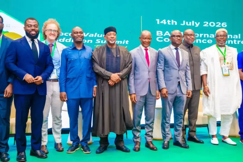 Group photograph of Dr. Olasupo Olusi, Senator John Owan Enoh, and international dignitaries on stage at the Cocoa Value Addition Summit